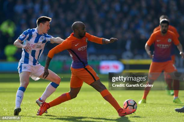 Martin Cranie of Huddersfield Town puts pressure on Fabian Delph of Manchester City during The Emirates FA Cup Fifth Round match between Huddersfield...