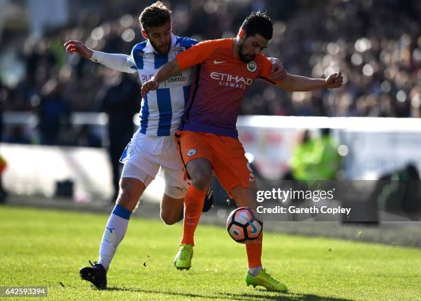 Martin Cranie of Huddersfield Town and Nolito of Manchester City battle for possession during The Emirates FA Cup Fifth Round match between...