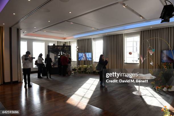 Guests look at the displays of jewellery during the Astley Clarke AW17 Presentation during London Fashion Week at Savoy Place on February 18, 2017 in...