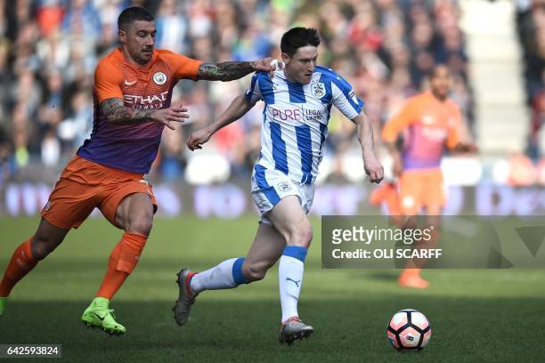 Huddersfield Town's English midfielder Joe Lolley vies with Manchester City's Serbian defender Aleksandar Kolarov during the English FA Cup fifth...