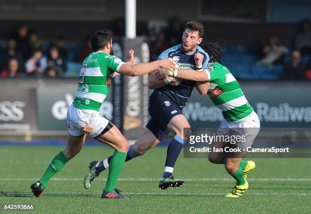 Cardiff Blues' Alex Cuthbert is tackled by is tackled by Benetton Treviso's Ian McKinley and Tito Tebaldi during the Guinness Pro12 Round 15 match...