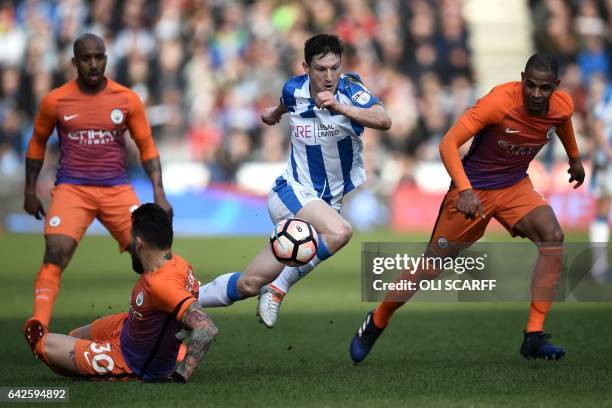 Huddersfield Town's English midfielder Joe Lolley runs through the Manchester City defence the English FA Cup fifth round football match between...