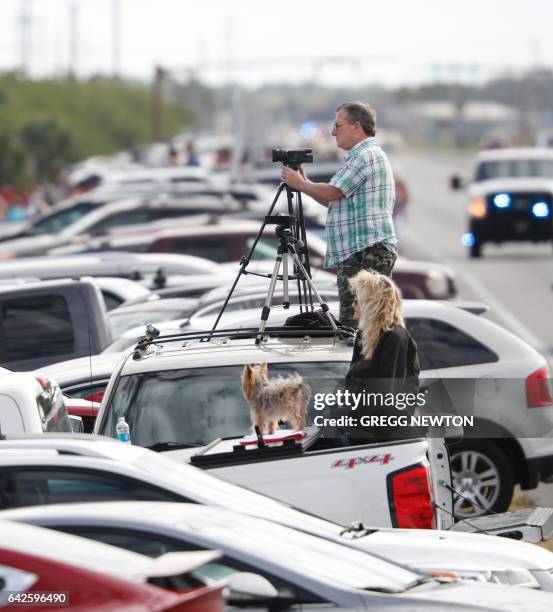 Spectators gather along a shore of Port Canaveral, Florida to watch the launch of a Falcon 9 rocket of SpaceX, ferrying cargo to the International...