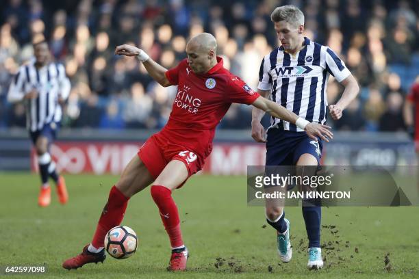 Millwall's English-born Welsh striker Steve Morison vies with Leicester City's French defender Yohan Benalouane during the English FA Cup fifth round...