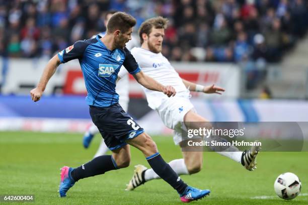 Andrej Kramaric of Hoffenheim scores his team's first goal against Peter Niemeyer of Darmstadt during the Bundesliga match between TSG 1899...