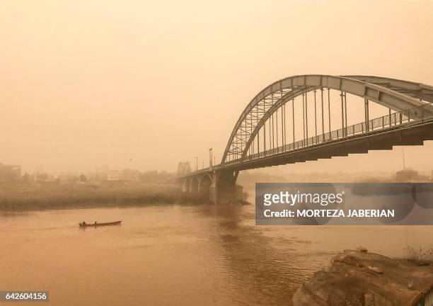 Picture taken on February 18, 2017 shows a general view of a bridge in the Iranian city of Ahvaz during a sandstorm. - At least seven people were...