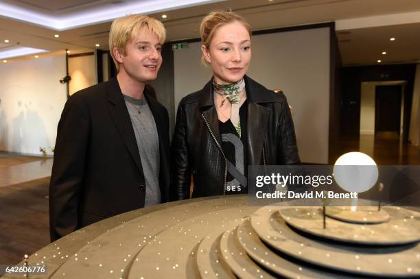 Creative director Dominic Jones speaks with model and actress Clara Paget during the Astley Clarke AW17 Presentation during London Fashion Week at...