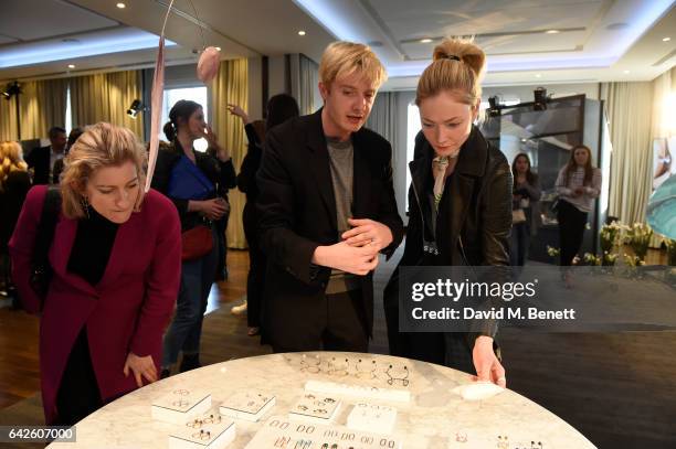 Creative director Dominic Jones shows the jewellery to model and actress Clara Paget during the Astley Clarke AW17 Presentation during London Fashion...