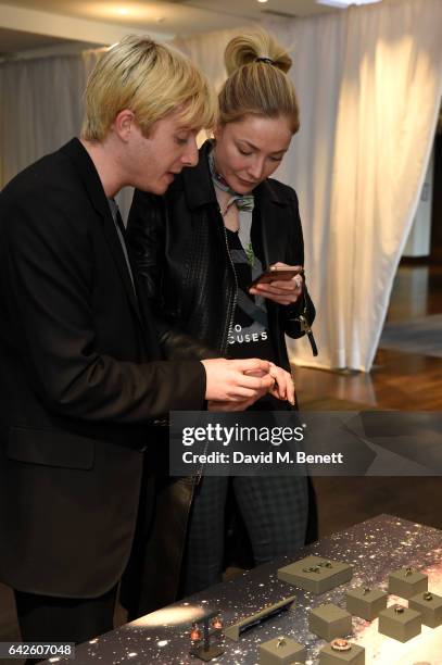 Creative director Dominic Jones shows the jewellery to model and actress Clara Paget during the Astley Clarke AW17 Presentation during London Fashion...