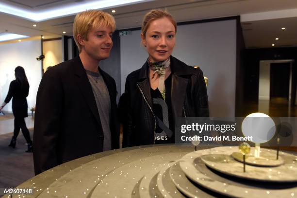 Creative director Dominic Jones shows the jewellery to model and actress Clara Paget during the Astley Clarke AW17 Presentation during London Fashion...