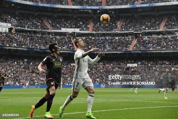 Real Madrid's Portuguese forward Cristiano Ronaldo vies with Espanyol's Paraguayan midfielder Hernan Perez during the Spanish league football match...