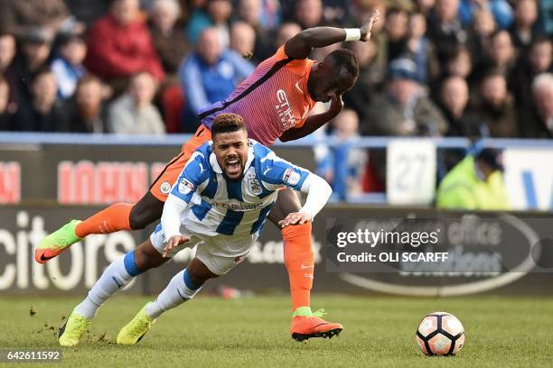 Huddersfield Town's German striker Elias Kachunga is fouled by Manchester City's French defender Bacary Sagna during the English FA Cup fifth round...