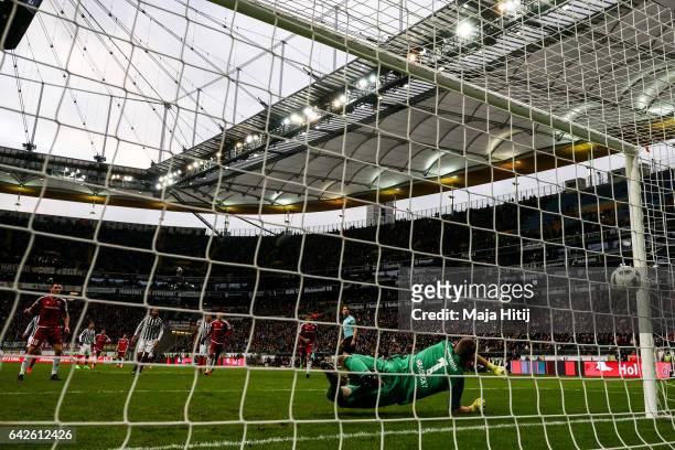 Pascal Gross of Ingolstadt scores penalty shot to make it 0-2 against Lukas Hradecky goal keeper of Frankfurt during the Bundesliga match between...