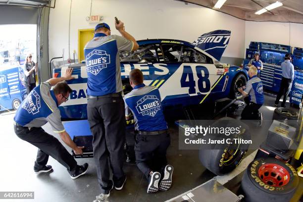Team members make adjustments to the Lowe's Chevrolet, driven by Jimmie Johnsonin the garage area during practice for the Monster Energy NASCAR Cup...