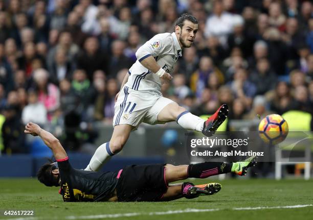 Gareth Bale of Real Madrid scores his team's second goal past Hernan Perez of RCD Espanyol during the La Liga match between Real Madrid and RCD...