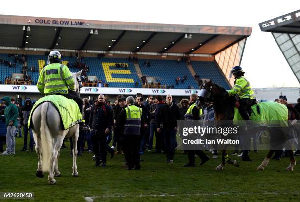 Police on horseback take control of the pitch invaders after The Emirates FA Cup Fifth Round match between Millwall and Leicester City at The Den on...