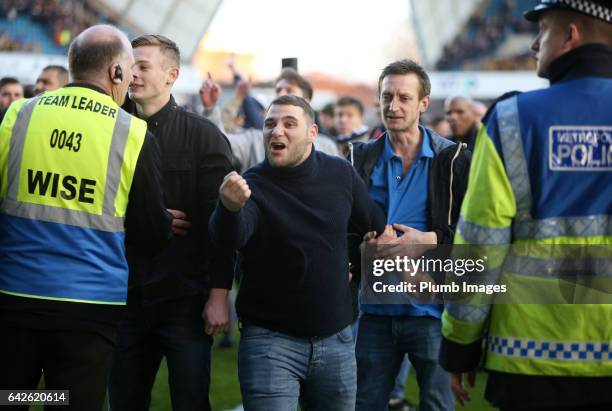 Millwall fans on the pitch after The Emirates FA Cup Fifth Round tie between Millwall and Leicester City at The Den on February 18, 2017 in London,...