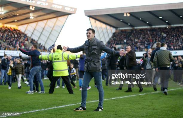 Millwall fans celebrate on the pitch after The Emirates FA Cup Fifth Round tie between Millwall and Leicester City at The Den on February 18, 2017 in...