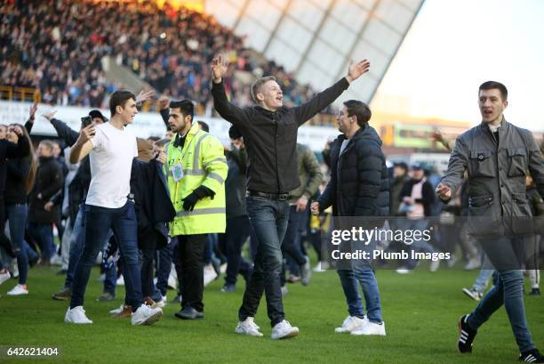 Millwall fans celebrate on the pitch after The Emirates FA Cup Fifth Round tie between Millwall and Leicester City at The Den on February 18, 2017 in...