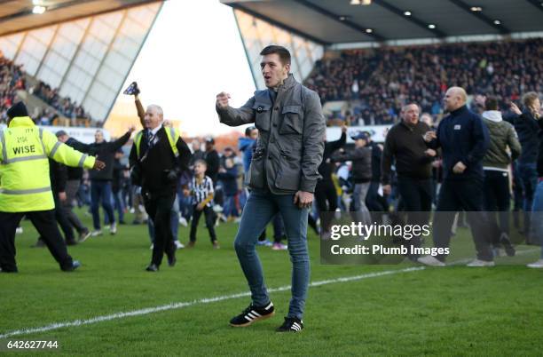 Millwall fans celebrate on the pitch after The Emirates FA Cup Fifth Round tie between Millwall and Leicester City at The Den on February 18, 2017 in...