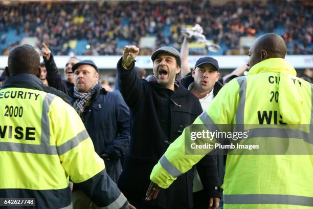 Millwall fans celebrate on the pitch after The Emirates FA Cup Fifth Round tie between Millwall and Leicester City at The Den on February 18, 2017 in...