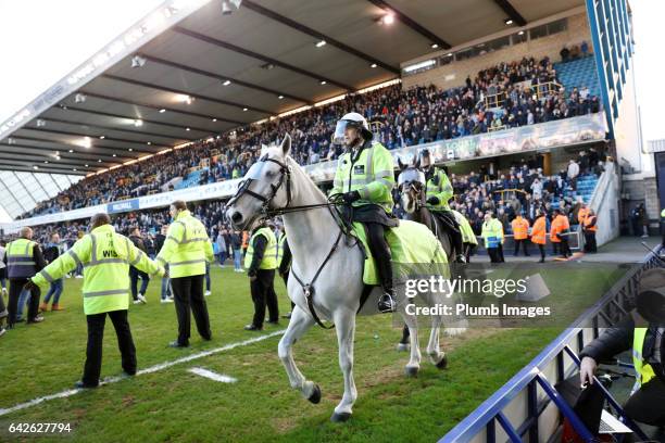 Millwall fans celebrate on the pitch after The Emirates FA Cup Fifth Round tie between Millwall and Leicester City at The Den on February 18, 2017 in...