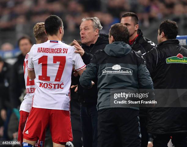 Christian Streich, head coach of Freiburg clashes with Filip Kostic of Hamburg during the Bundesliga match between Hamburger SV and SC Freiburg at...