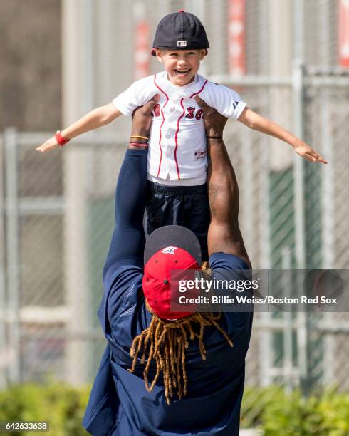 Hanley Ramirez picks up the son of Dustin Pedroia of the Boston Red Sox during a team workout on February 18, 2017 at Fenway South in Fort Myers,...