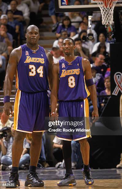 Kobe Bryant of the Los Angeles Lakers stands next to his teammate, Shaquille O'Neal, during game 1 of the Western Conference Finals during the 2002...