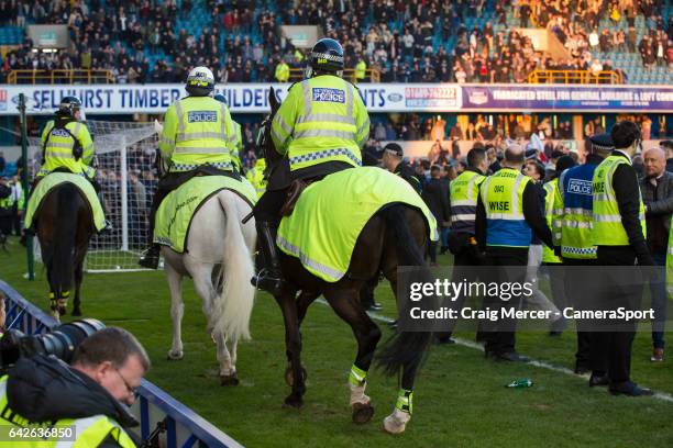 Police horses called in to help calm the pitch invasion by Millwall fans during the Emirates FA Cup Fifth Round match between Millwall v Leicester...