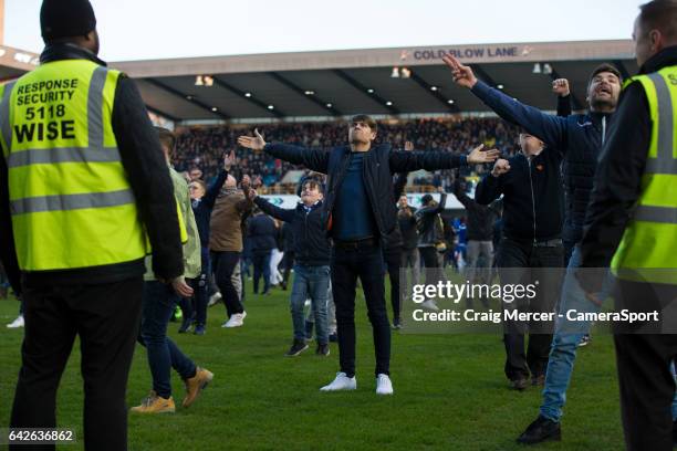 Millwall fans celebrate their victory by invading the pitch at full time and taunting the away fans during the Emirates FA Cup Fifth Round match...