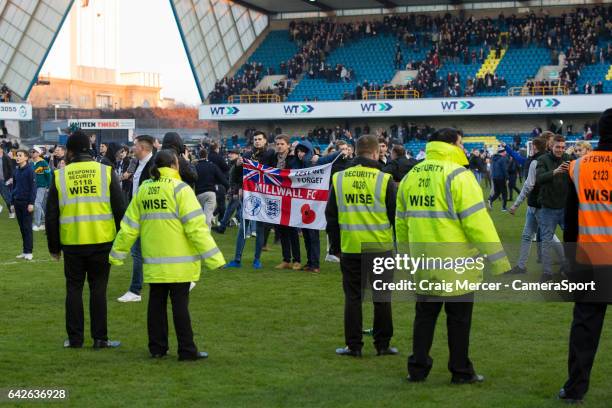 Millwall fans celebrate their victory by invading the pitch at full time during the Emirates FA Cup Fifth Round match between Millwall v Leicester...