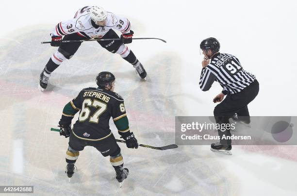 Cordell James of the Owen Sound Attack gets set to take a faceoff against Mitchell Stephens of the London Knights during an OHL game at Budweiser...