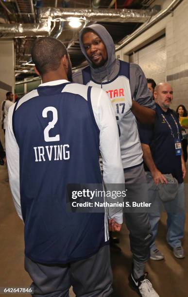 Kyrie Irving of the Eastern Conference All Star Team talks in the halls with Kevin Durant of the Western Conference All Star Team before NBA All-Star...