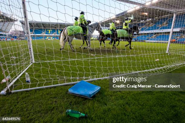 Debris of coins and bottles and a broken seat are seen on the pitch having been thrown onto the field after Millwall fans staged a pitch invasion at...