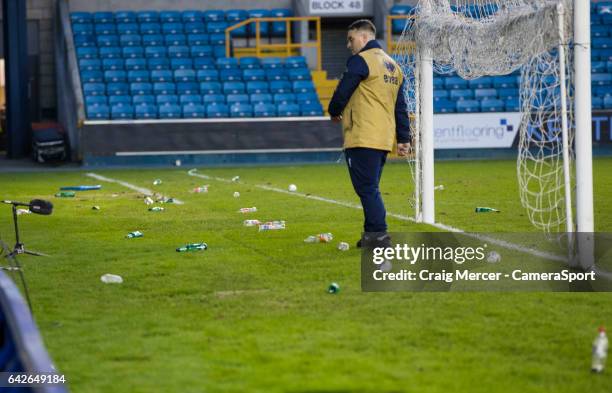 Debris of coins and bottles and a broken seat are seen on the pitch having been thrown onto the field after Millwall fans staged a pitch invasion at...