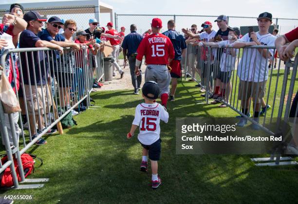 Dustin Pedroia of the Boston Red Sox is followed by his son Brooks as he runs to a practice field on February 18, 2017 at jetBlue Park in Fort Myers,...