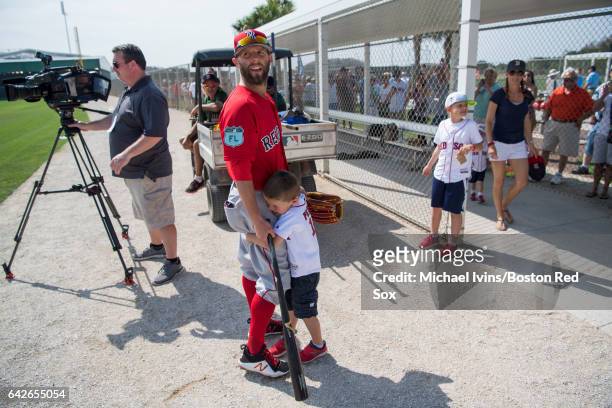 Dustin Pedroia of the Boston Red Sox gets a hug from his son Cole during a break in practice on February 18, 2017 at jetBlue Park in Fort Myers,...
