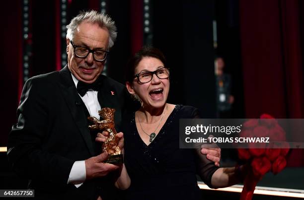 Hungarian director Ildiko Enyedi poses with the Golden Bear for Best Film "On Body and Soul" and Berlinale Director Dieter Kosslick at the awards...