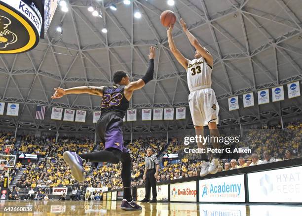 Guard Conner Frankamp of the Wichita State Shockers hits a three-point shot over guard Jordan Ashton of the Northern Iowa Panthers during the first...