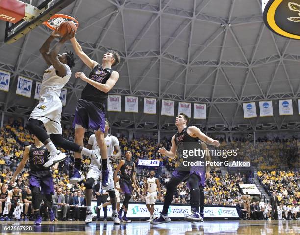 Forward Bennett Koch of the Northern Iowa Panthers blocks the driving shot attempt of forward Zach Brown of the Wichita State Shockers during the...