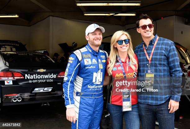 Dale Earnhardt Jr., driver of the Nationwide Chevrolet, talks to IndyCar driver Graham Rahal and his wife, Courtney Force during practice for the...