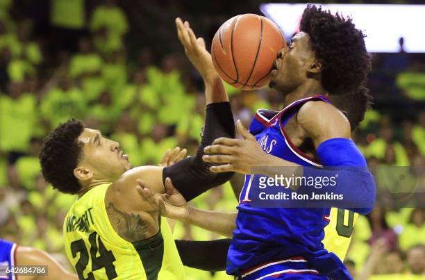 Josh Jackson of the Kansas Jayhawks has the ball deflect off his face as Ishmail Wainright of the Baylor Bears defends in the second half at the...