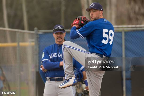 Pitching coach Pete Walker watches as Casey Lawrence throws from the mound. Toronto Blue Jays welcome the entire squad today as position players join...