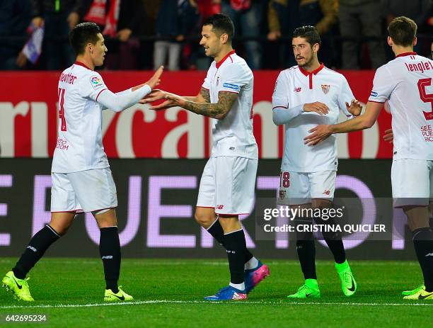 Sevilla's midfielder Vitolo celebrates with teammates after scoring during the Spanish league football match Sevilla FC vs SD Eibar on February 18,...