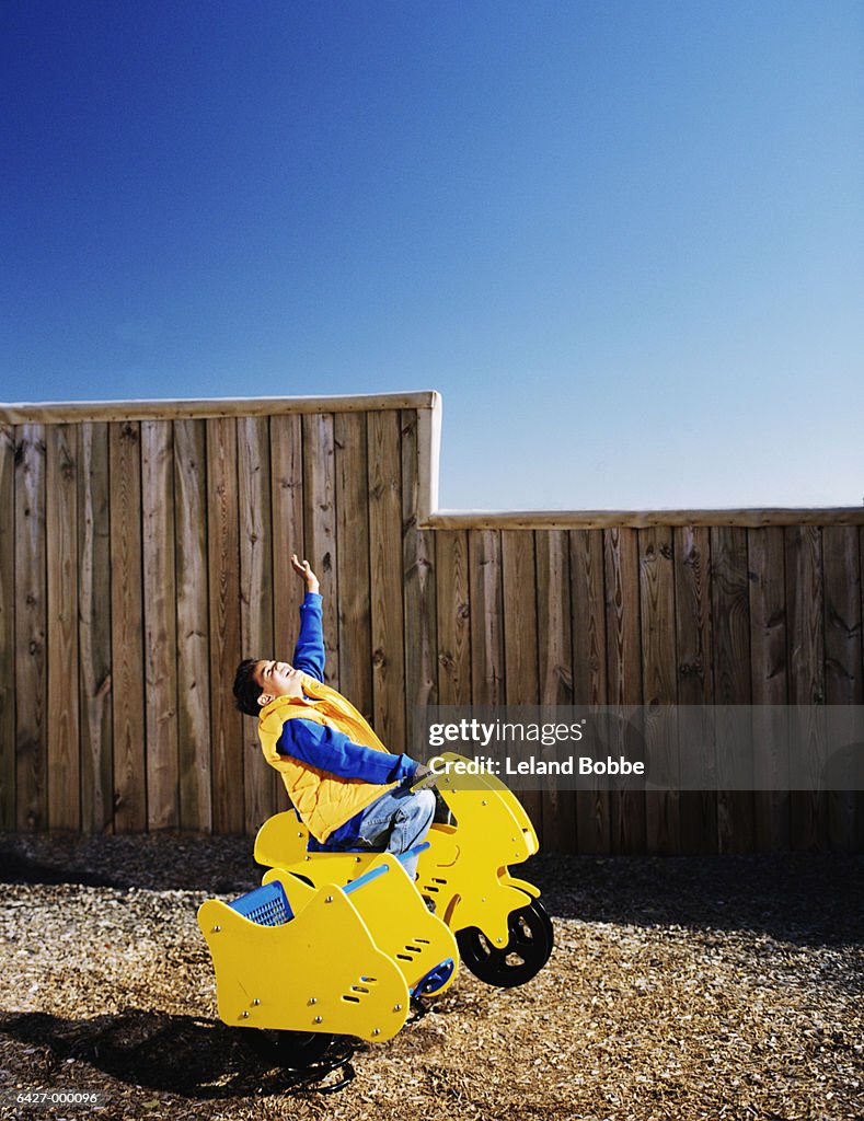 Boy on Playground Motorbike