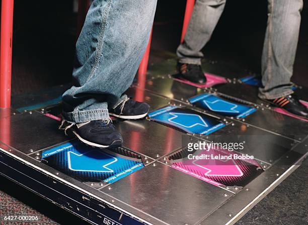 people playing on dance game - amusement arcade stock-fotos und bilder