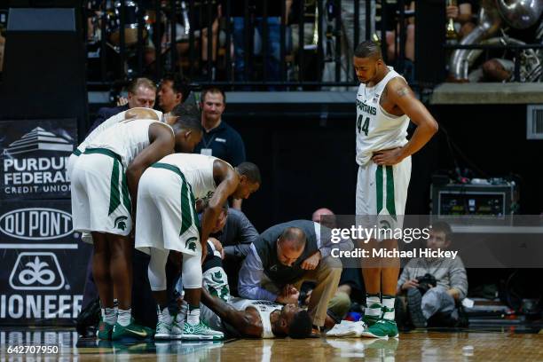 Members of the Michigan State Spartans tend to injured player Eron Harris during the game against the Purdue Boilermakers at Mackey Arena on February...