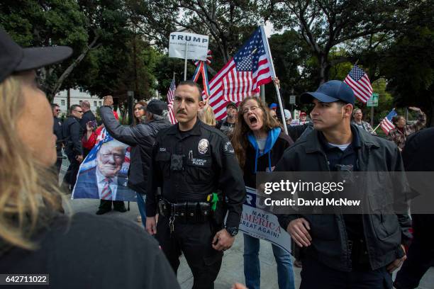 Trump supporter yells at a marcher during the Immigrants Make America Great March to protest actions being taken by the Trump administration on...