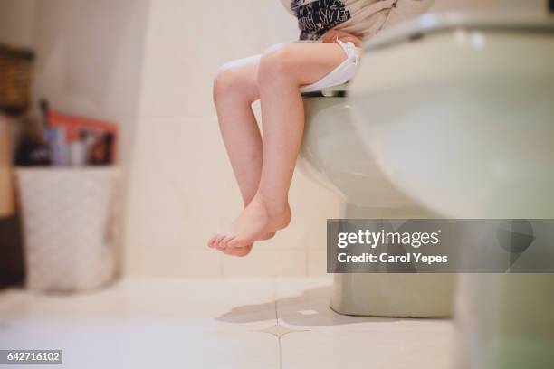 child sitting in toilet.low section - childrens closet stockfoto's en -beelden